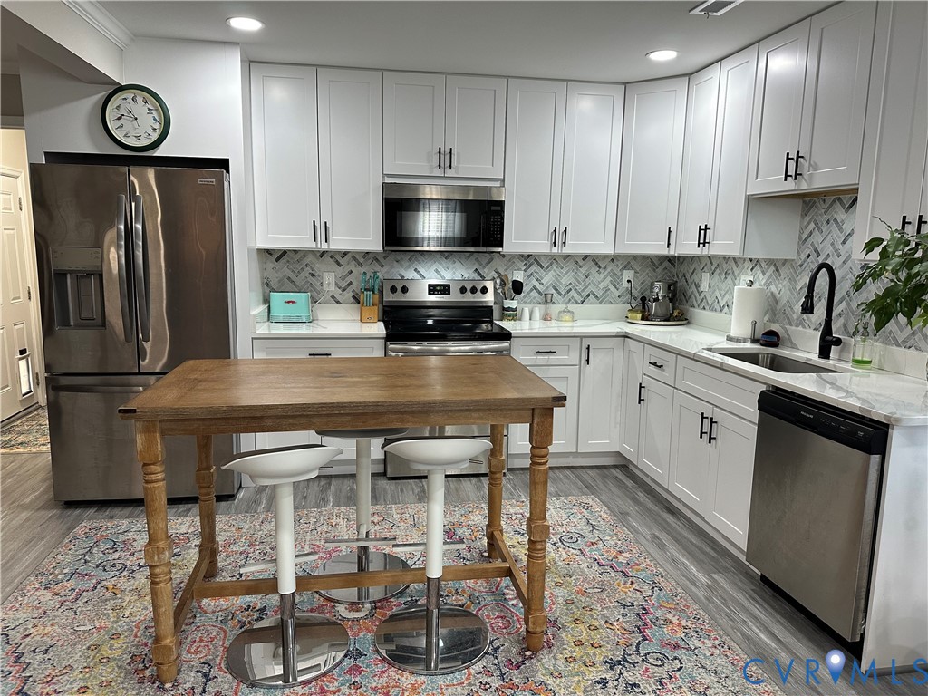 305 Myrtle Street, Unit A Ashland, VA 23005 - Photo 15 of 59 a kitchen with a sink cabinets and stainless steel appliances