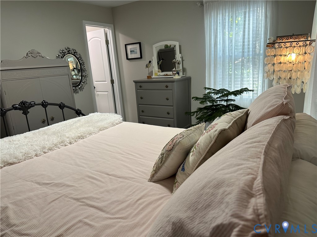 305 Myrtle Street, Unit A Ashland, VA 23005 - Photo 21 of 59 a bedroom with a bed and dresser with mirror