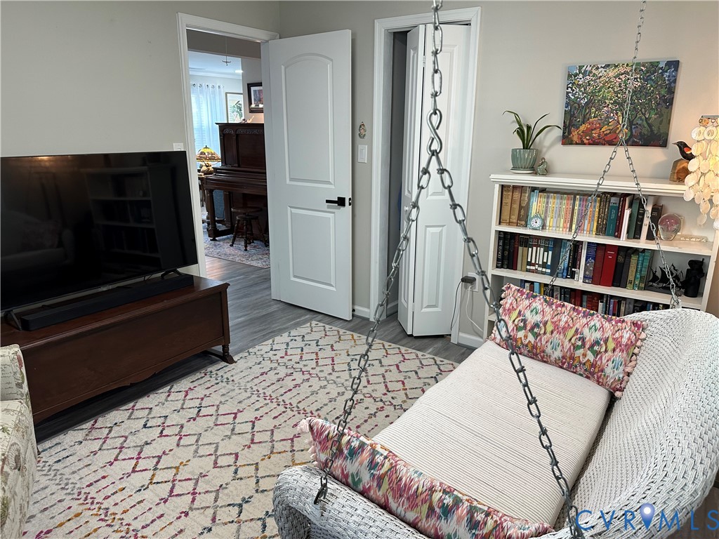 305 Myrtle Street, Unit A Ashland, VA 23005 - Photo 27 of 59 a living room with a couch and a book shelf