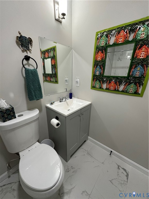 305 Myrtle Street, Unit A Ashland, VA 23005 - Photo 29 of 59 a bathroom with a toilet sink and mirror