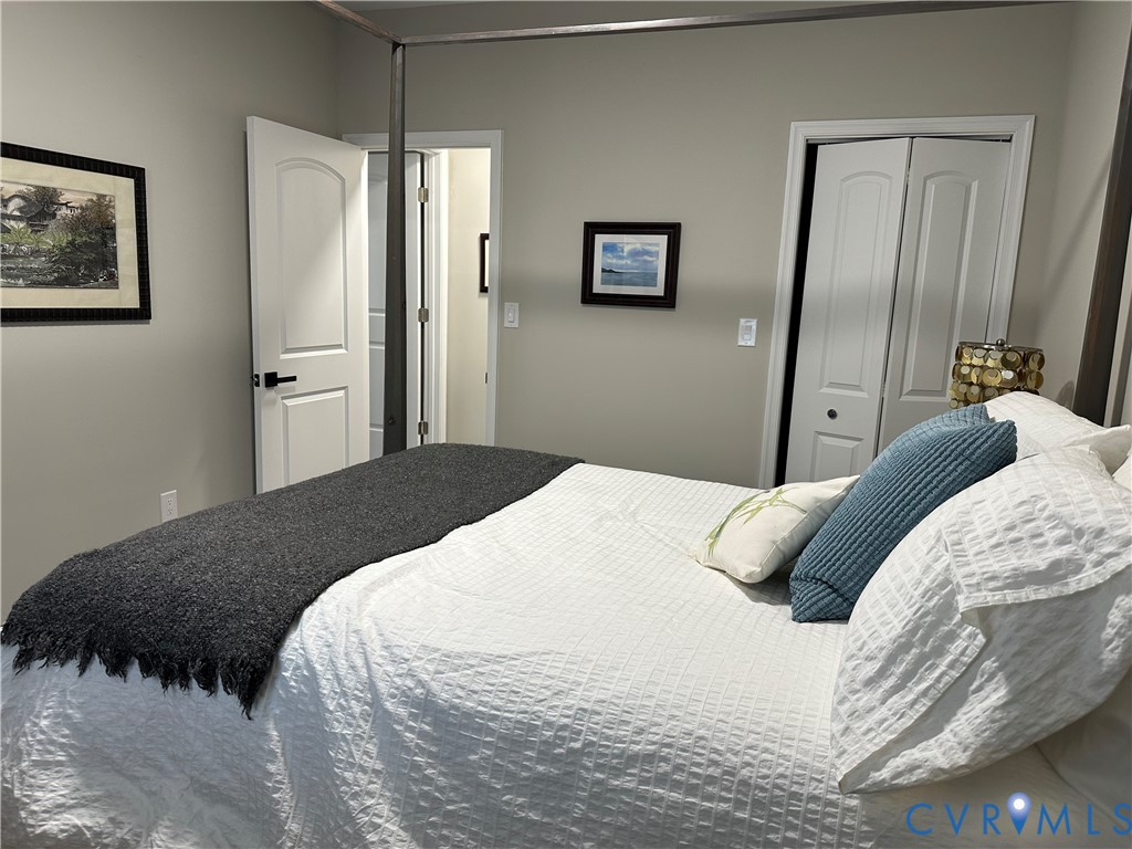 305 Myrtle Street, Unit A Ashland, VA 23005 - Photo 36 of 59 a bedroom with a bed and a large mirror