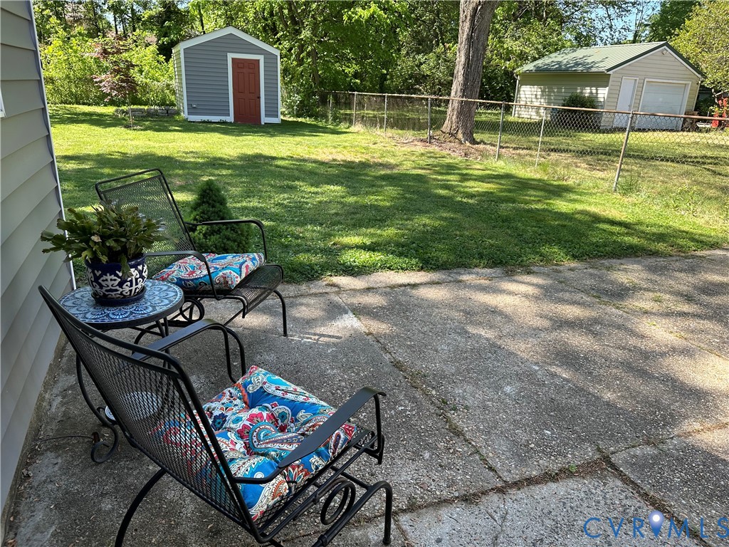 305 Myrtle Street, Unit A Ashland, VA 23005 - Photo 41 of 59 a backyard of a house with table and chairs