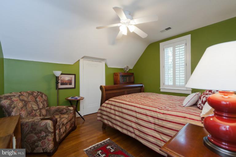 2012 South Arlington Ridge Road Arlington, VA 22202 - Photo 21 of 30 a bedroom with a bed and a chandelier