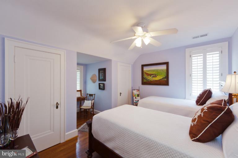 2012 South Arlington Ridge Road Arlington, VA 22202 - Photo 5 of 30 a bedroom with a bed and a chandelier