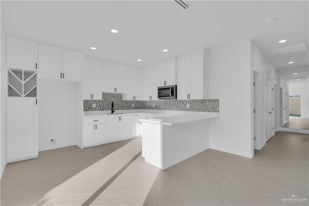 2903 Gabriel Street, Unit 3 Mission, TX 78574 - Photo 4 of 12 a kitchen with white cabinets appliances and sink