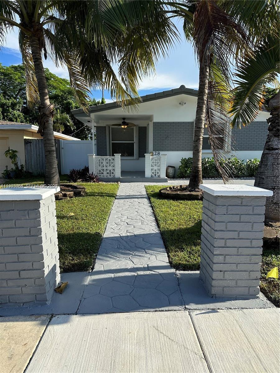 28 Southeast 4th Street Dania Beach, FL 33004 - Photo 2 of 14 front view of a house with a garden