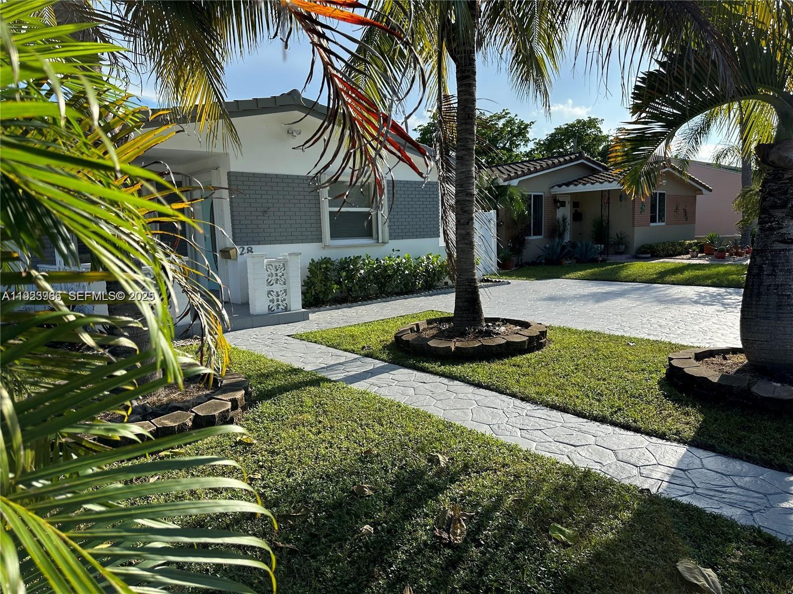 28 Southeast 4th Street Dania Beach, FL 33004 - Photo 3 of 14 a view of a house with a yard
