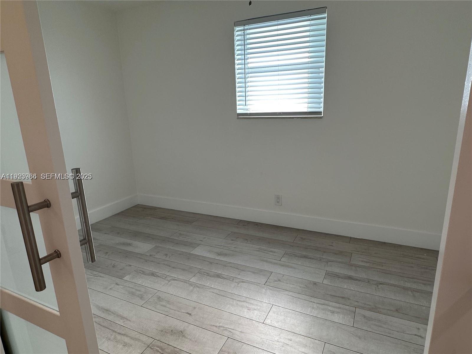 28 Southeast 4th Street Dania Beach, FL 33004 - Photo 8 of 14 an empty room with a window