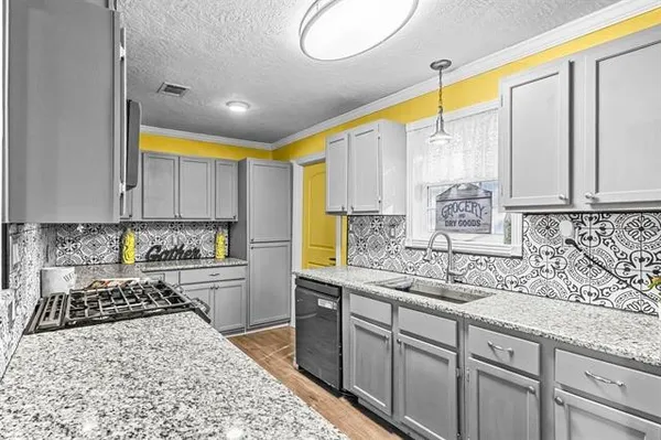 a kitchen with stainless steel appliances granite countertop a sink stove and cabinets