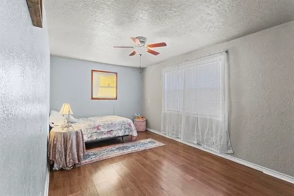 a bedroom with furniture and wooden floor