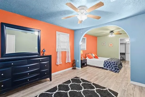 a bedroom with a bed and a chandelier
