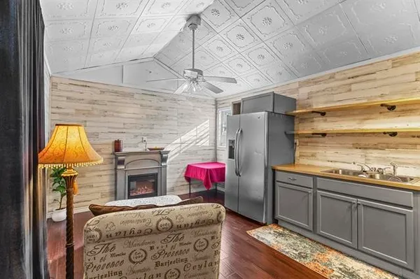 a utility room with stainless steel appliances wooden floor and chandelier