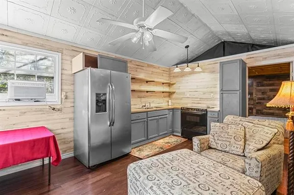 a kitchen with stainless steel appliances kitchen island granite countertop a refrigerator and a stove top oven