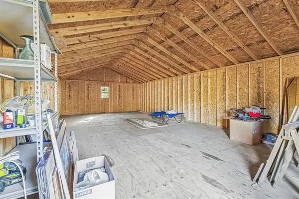 a view of a room with furniture and a flat screen tv
