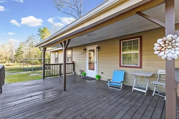 a view of a house with a porch and furniture