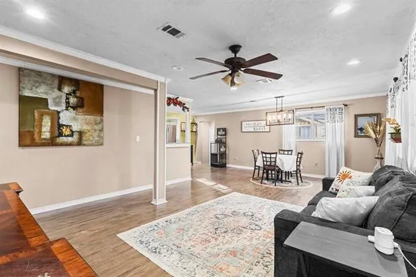 a living room with furniture and a wooden floor