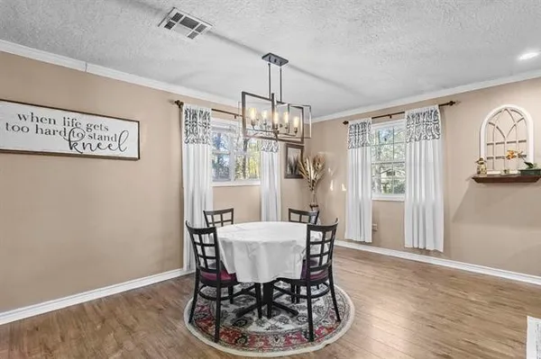 a view of a dining room with furniture window and wooden floor
