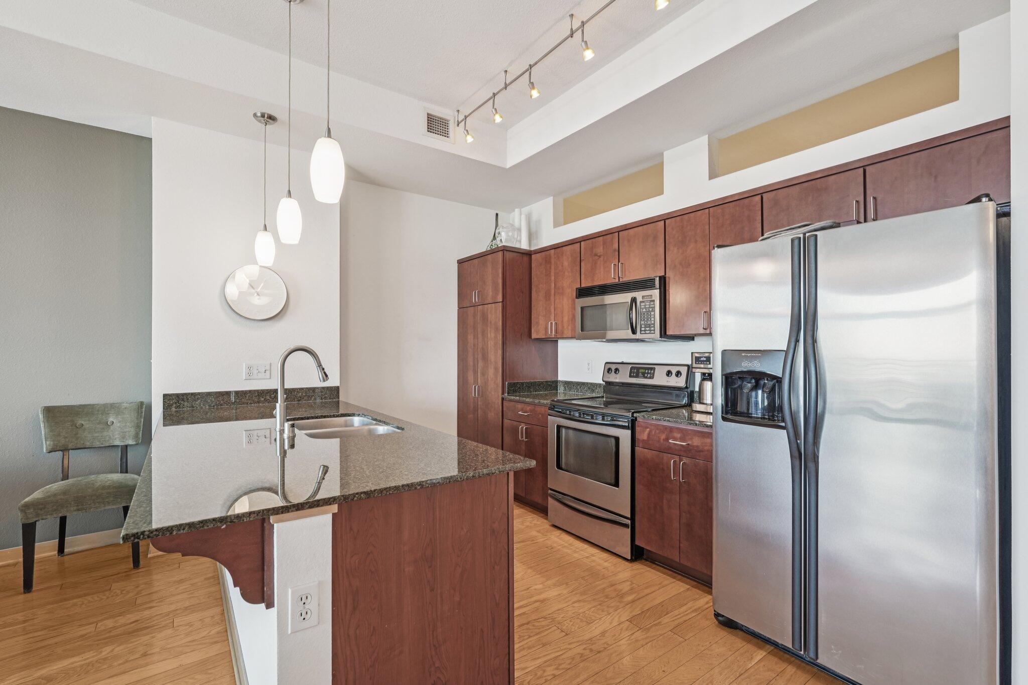 106 West Seeboth Street, Unit 908 Milwaukee, WI 53204 - Photo 16 of 48 Kitchen and island.