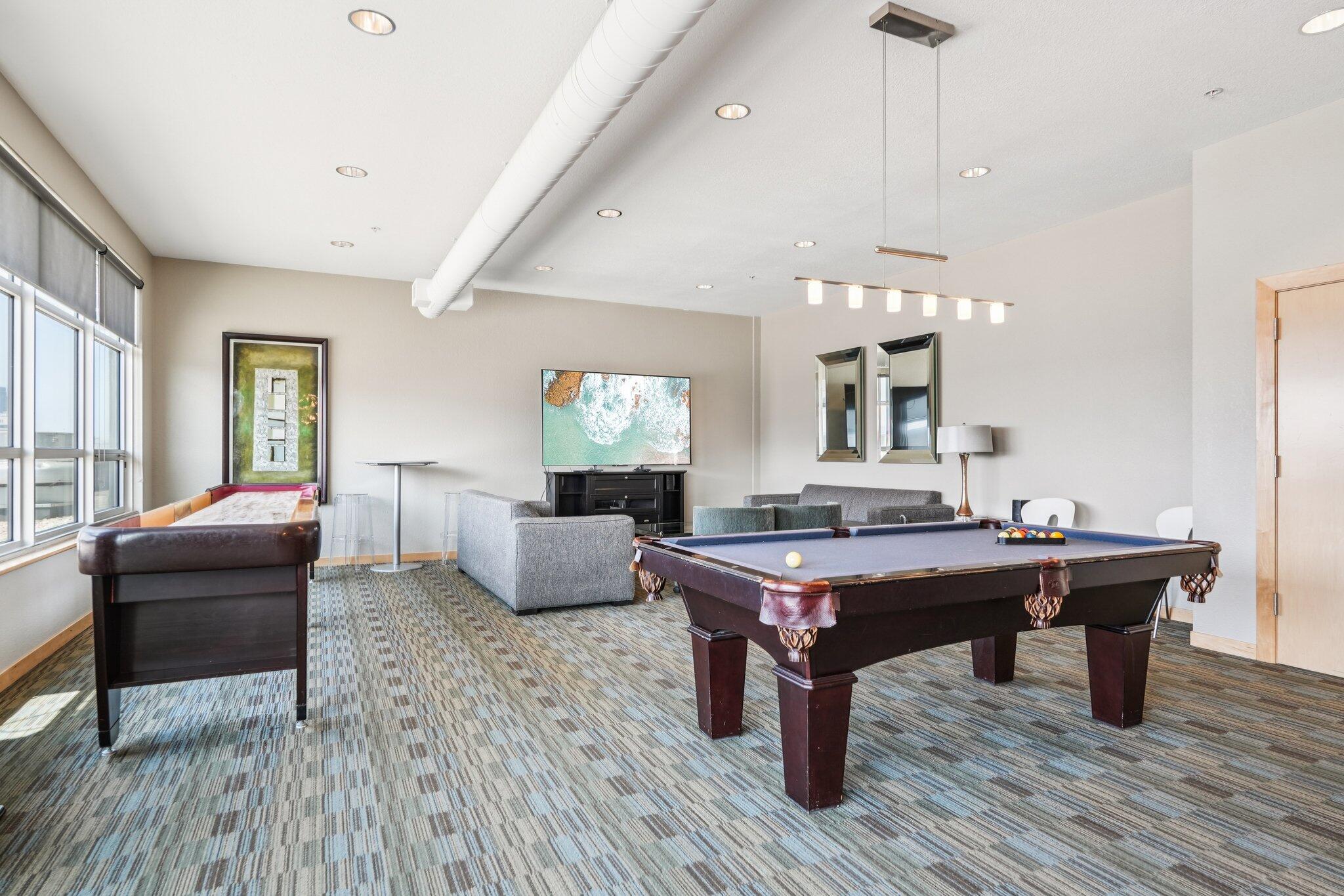 106 West Seeboth Street, Unit 908 Milwaukee, WI 53204 - Photo 30 of 48 Enjoy the Social Networking Room, with Pool tables, kitchen, Poker Table, Cocktail high top tables, TV and seating area.