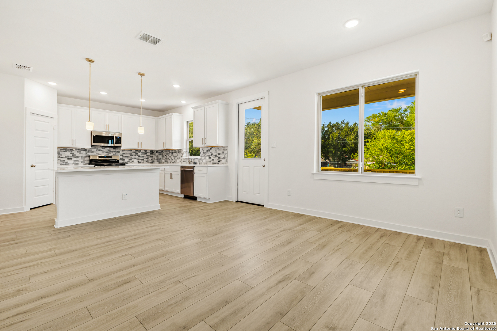 116 Vertex Loop San Antonio, TX 78238 - Photo 11 of 27 a view of a kitchen with a stove cabinets and a wooden floor