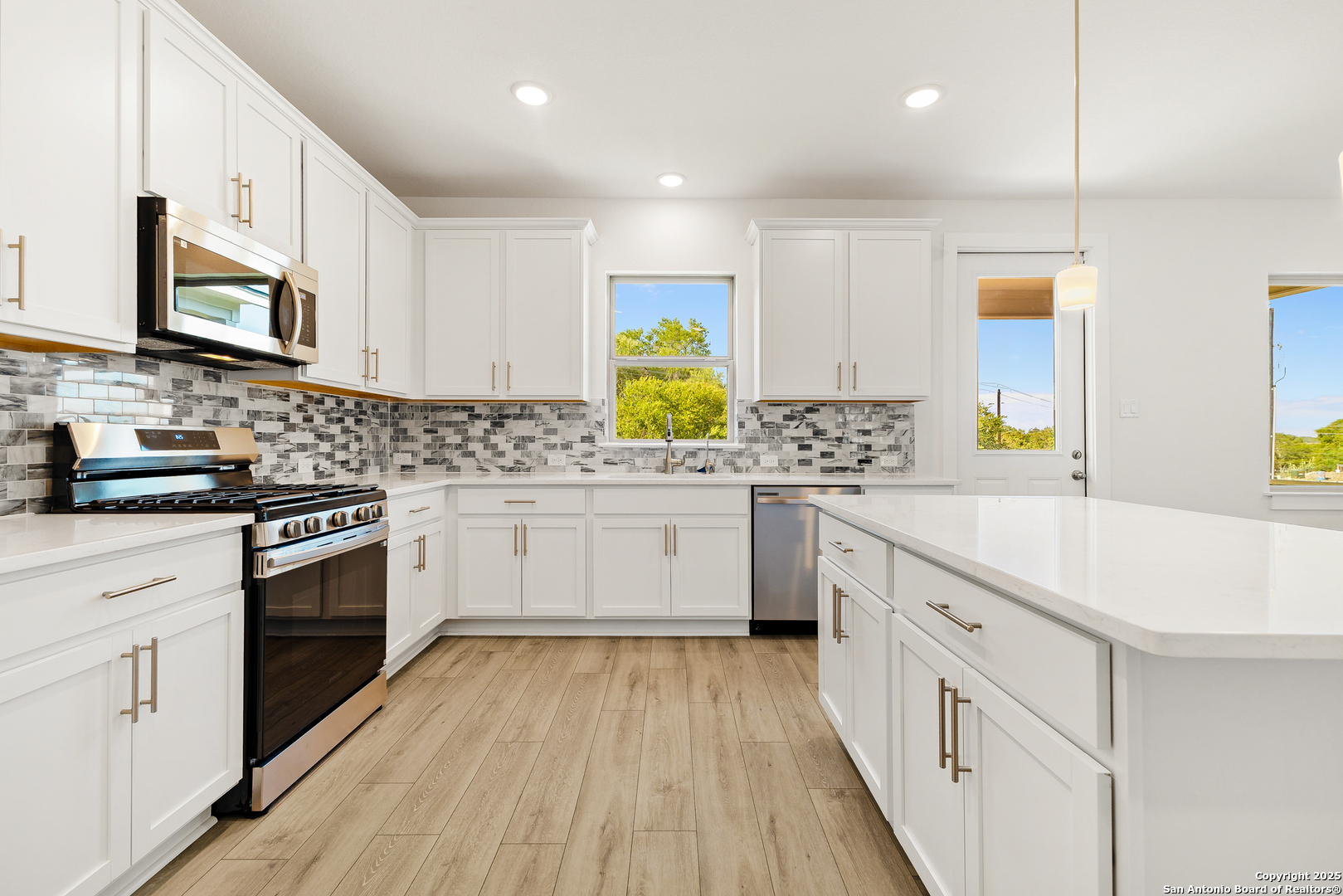 116 Vertex Loop San Antonio, TX 78238 - Photo 14 of 27 a kitchen with stainless steel appliances sink stove top oven and cabinets