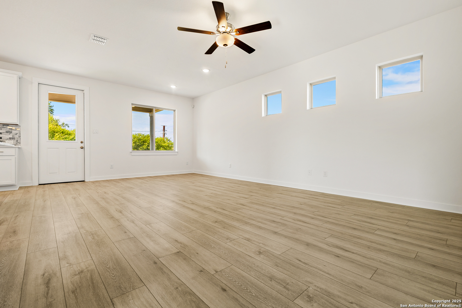 116 Vertex Loop San Antonio, TX 78238 - Photo 7 of 27 wooden floor in an empty room with a window