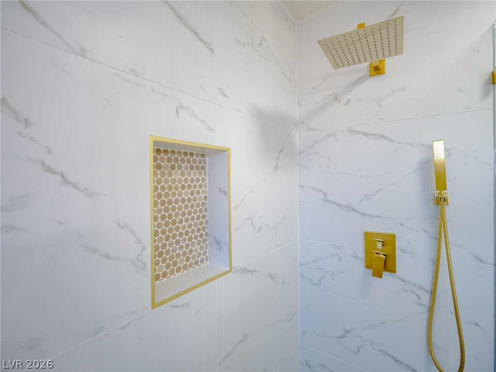 321 Lakehurst Road Las Vegas, NV 89145 - Photo 25 of 33 Marble-patterned tile surrounds the walk-in shower with premium gold-toned fixtures.