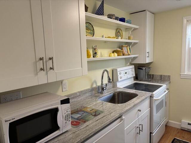 221 Upper County Road, Unit 2A Dennis Port, MA 02639 - Photo 3 of 6 a kitchen with stainless steel appliances granite countertop a sink a refrigerator and a stove