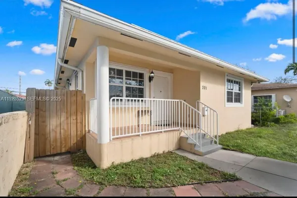 a view of a house with a small yard and plants