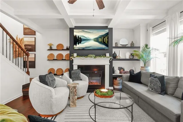 a living room with furniture a fireplace and a large window