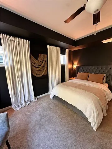 a bedroom with a bed and a large mirror