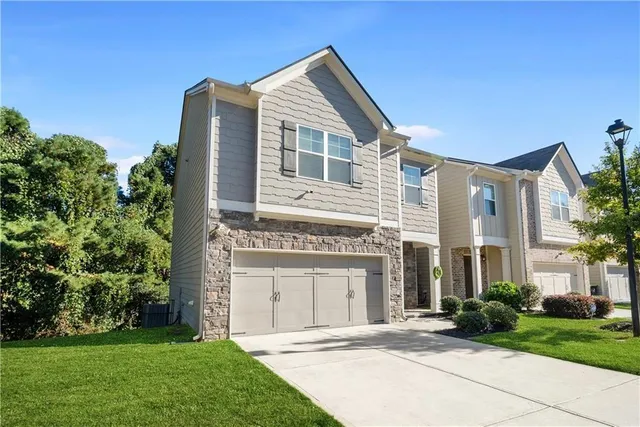 a front view of a house with a garden