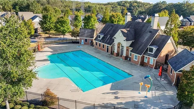 an aerial view of a house with a yard basket ball court and outdoor seating