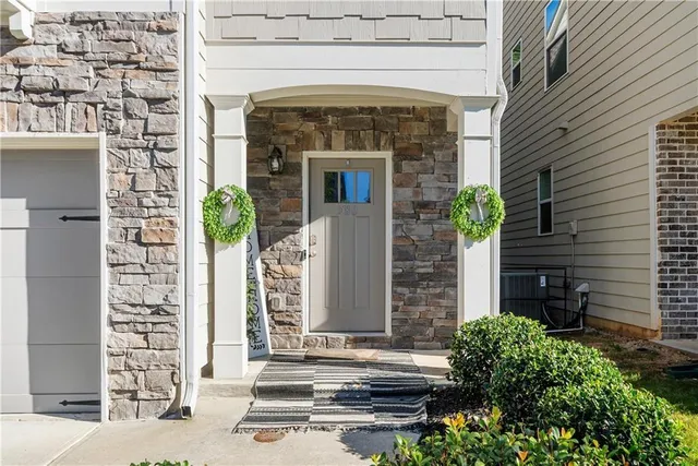 a front view of a house with plants