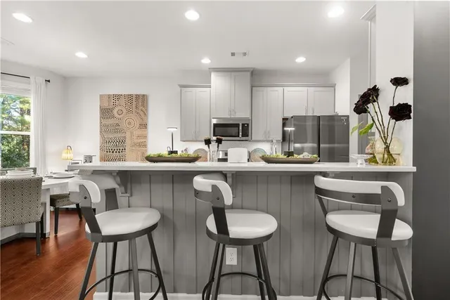 a kitchen with a table chairs stove and microwave