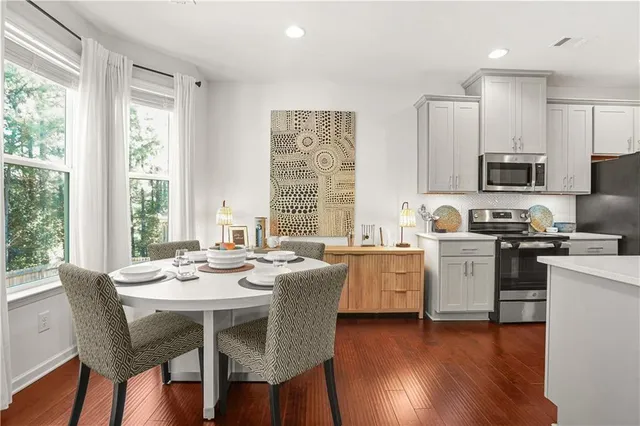 a kitchen with sink microwave and dining table