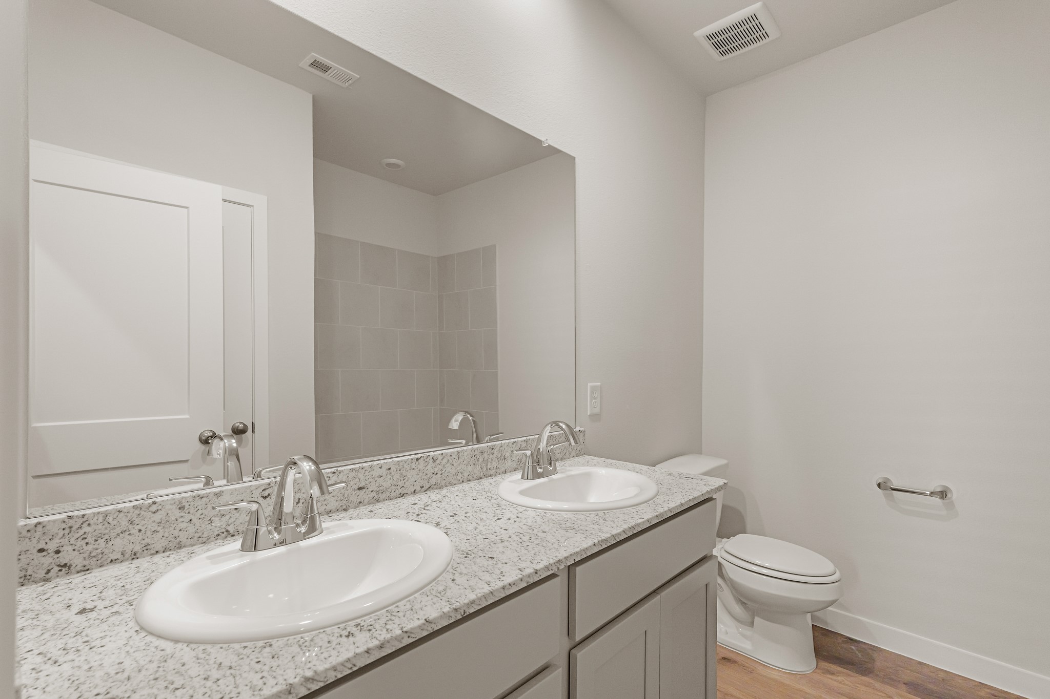 16715 Holly Street Porter, TX 77365 - Photo 4 of 26 a bathroom with a granite countertop sink a toilet and a mirror