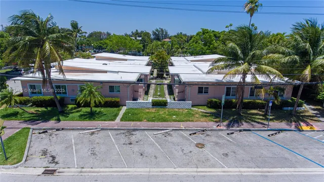 a front view of house with a garden