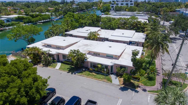 an aerial view of a house with a garden and lake view