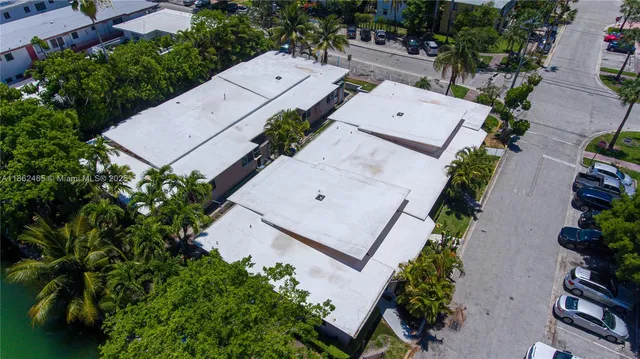 an aerial view of house with yard and ocean view