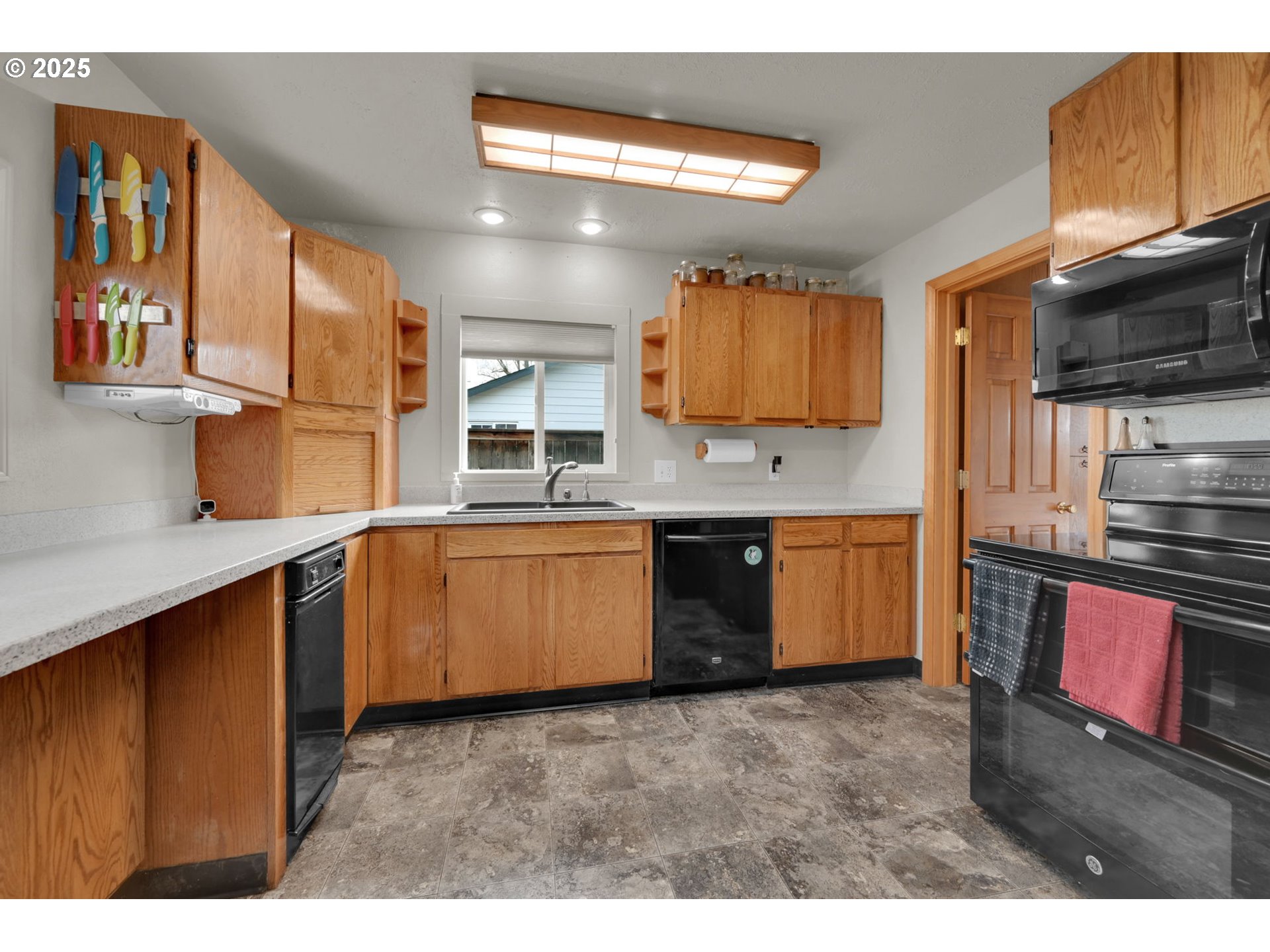 1105 West Fairview Drive Springfield, OR 97477 - Photo 13 of 46 a kitchen with stainless steel appliances granite countertop a sink counter space cabinets and a window