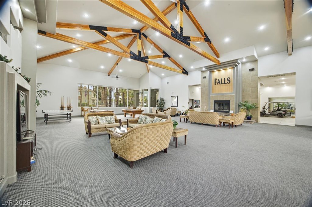 9050 West Warm Springs Road, Unit 1033 Las Vegas, NV 89148 - Photo 24 of 26 A spacious clubhouse lounge with high vaulted ceilings and a grand stone fireplace offers communal gathering spaces.
