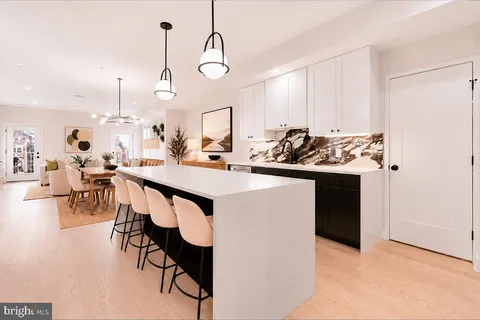 a stove top oven sitting inside of a kitchen