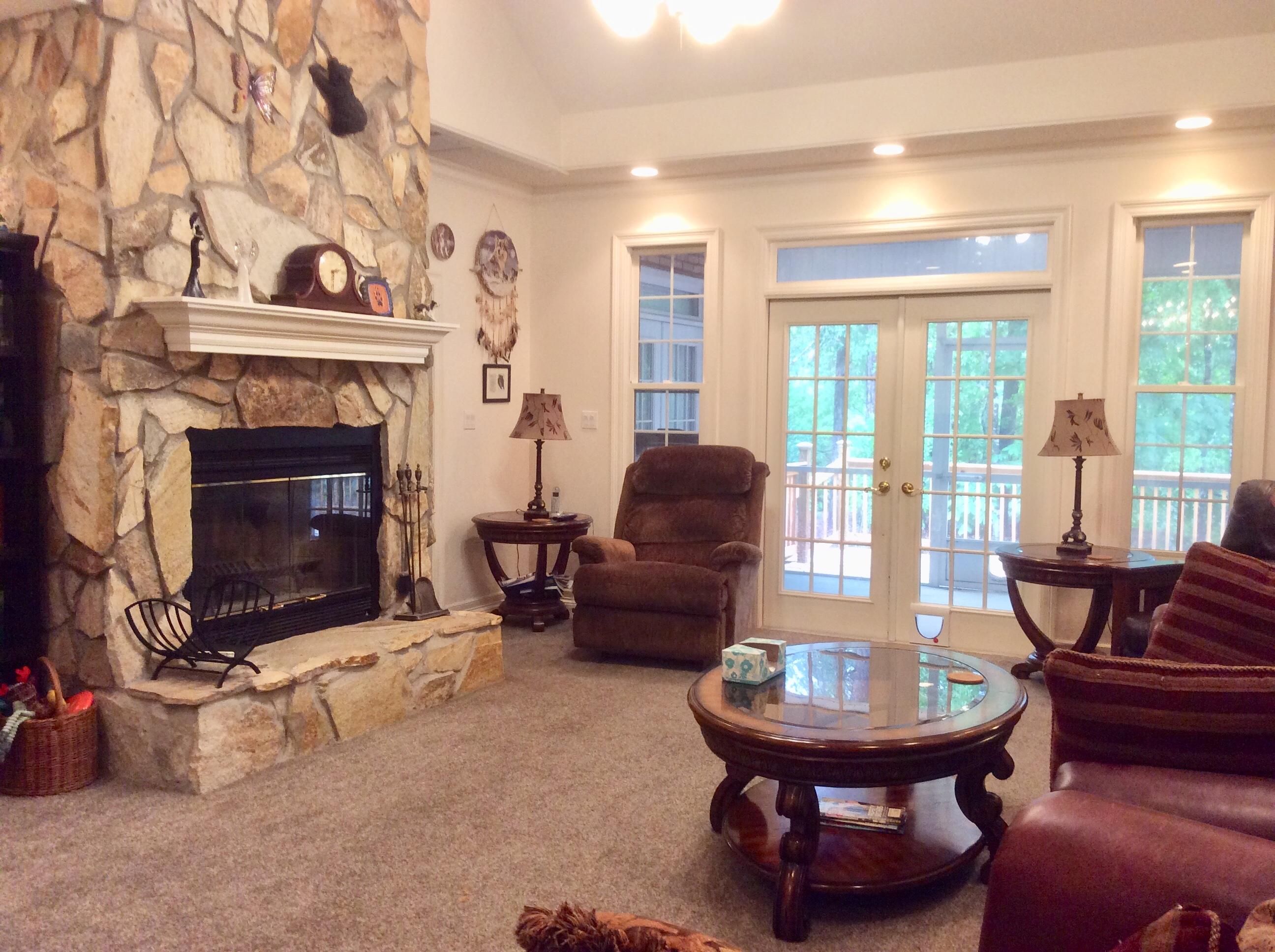 6089 Clear Creek Road Crestview, FL 32539 - Photo 6 of 38 a living room with furniture a fireplace and a table