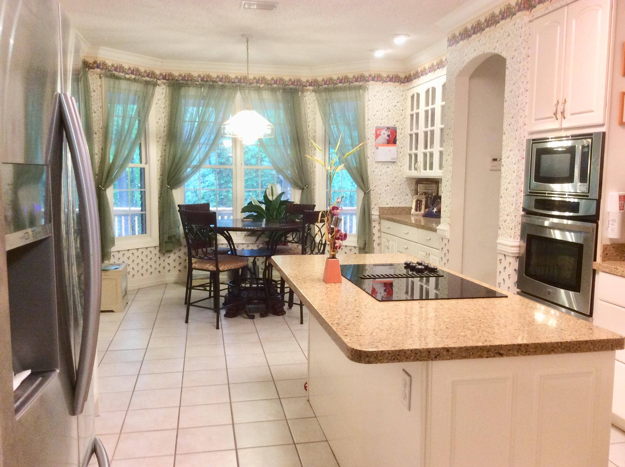 6089 Clear Creek Road Crestview, FL 32539 - Photo 10 of 38 a kitchen with stainless steel appliances granite countertop a refrigerator and a sink