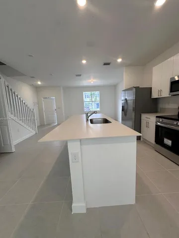 a stove top oven sitting inside of a kitchen