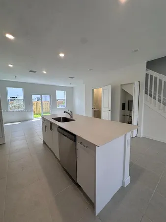 a stove top oven sitting inside of a kitchen