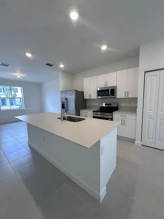 a kitchen with stainless steel appliances granite countertop a stove and a refrigerator