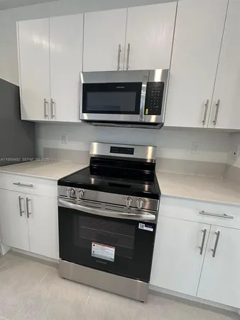 a large kitchen with stainless steel appliances lots of counter top space