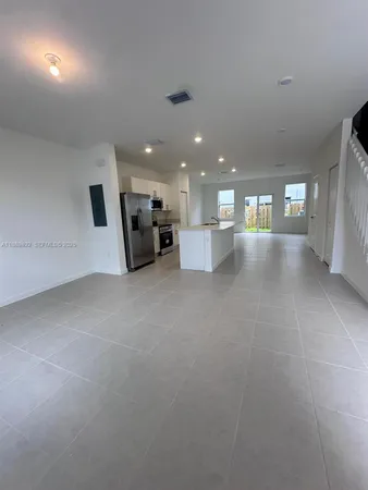 a view of a hall with kitchen